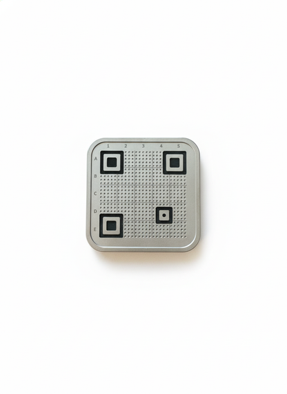 Small metallic square with QR codes on a white background